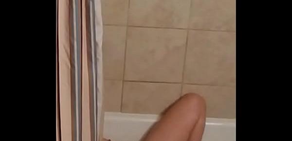  Spying on MILF enjoying a dildo in the bath.